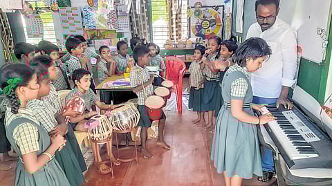 M Muthu Durai, teacher of Panchayat Union Primary School in Kurunchankkulam of 
Tenkasi district, taking classes to students using musical instruments 