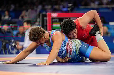 India's Reetika (in red) and Hungary's Bernadett Nagy (in blue) compete in women's freestyle wrestling 76kg pre-quarterfinal match at the 2024 Summer Olympics, in Paris, France, Saturday, Aug. 10, 2024.