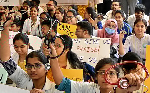 Members of Karnataka Association of Resident Doctors demand hike in their stipend and other demands during their protest at Freedom Park in Bengaluru on Monday.