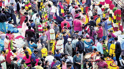 Ahead of the Varamahalakshmi festival, people throng KR Market to purchase flowers and pooja items on Wednesday.