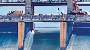 A crane at work over the broken crest gate no. 19 of TB Dam in Hosapete on Thursday.