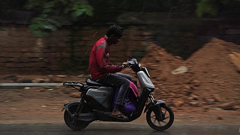 A gig worker seen navigating during heavy rain in Bengaluru