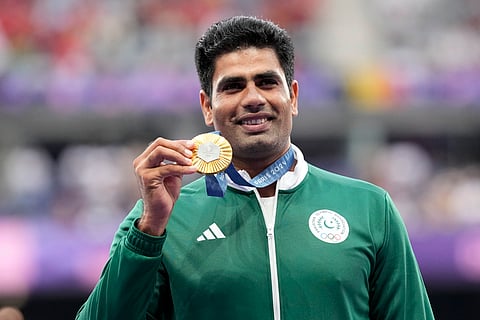 Men's javelin gold medalist, Arshad Nadeem, of Pakistan, waves on the podium at the 2024 Summer Olympics.