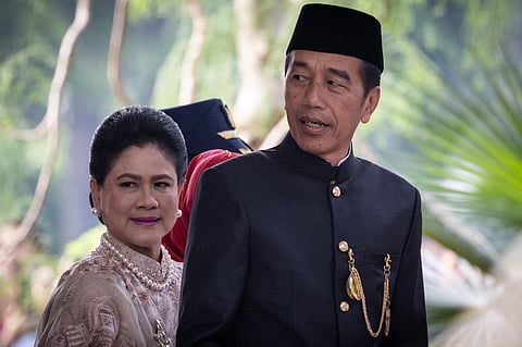 Indonesia's President Joko Widodo (R) and First Lady Iriana Iriana Widodo arrive to attend the annual session of the People's Consultative Assembly (MPR) at the parliament building in Jakarta on August 16