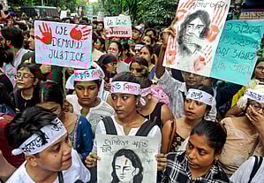 Women hold posters during an early morning protest against the alleged sexual assault and murder of a trainee doctor at Kolkata's RG Kar Medical College and Hospital, in Siliguri, Monday, Sept 9, 2024.