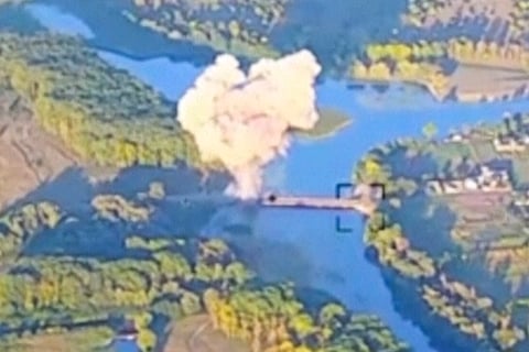 In this footage released by the Ukrainian armed forces on Sunday, Aug. 18, 2024, smoke billows in what is said to show the destruction of a key bridge in Russia's Kursk region.
