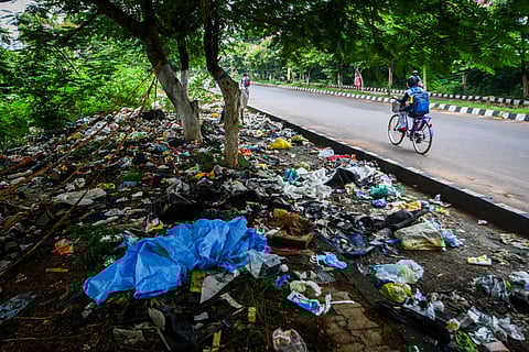 Garbage including medical waste thrown on the footpath alongside AIIMS Road in Bhubaneswar. 