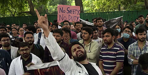 Doctors shout slogans during a protest over their safety in the wake of RG Kar Medical College incident, at Nirman Bhawan in New Delhi. 