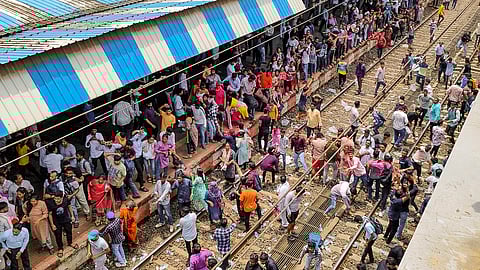 Angry people block railway tracks at Badlapur railway station in protest against the alleged sexual abuse of two girls at a school, in Thane district.