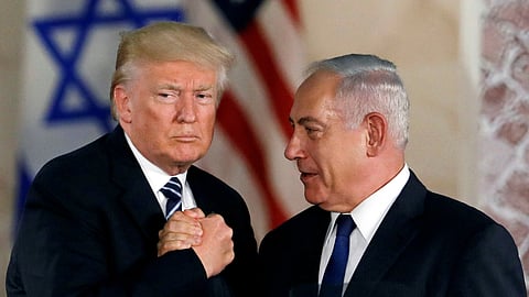 Then US President Donald Trump (L) poses with Israeli Prime Minister Benjamin Netanyahu (R) at the Israel Museum in Jerusalem in February 2019.