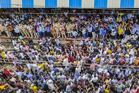 Police personnel speak with people blocking railway tracks in protest against the alleged sexual assault and murder of a postgraduate trainee doctor in Kolkata, at Badlapur railway station, in Thane district, Tuesday, Aug. 20, 2024. 