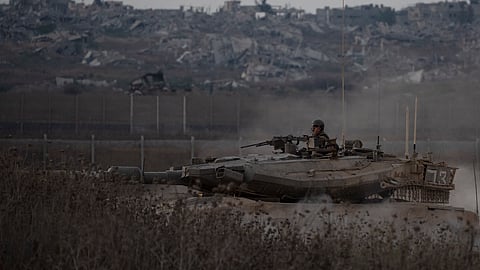 Israeli soldiers move on the top of a tank near the Israeli-Gaza border, as seen from southern Israel, Wednesday, Aug. 21, 2024. 