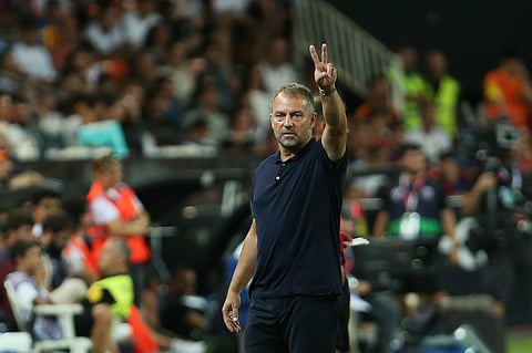 Barcelona's head coach Hansi Flick gestures during the Spanish La Liga soccer match between Valencia and FC Barcelona at the Mestalla stadium.