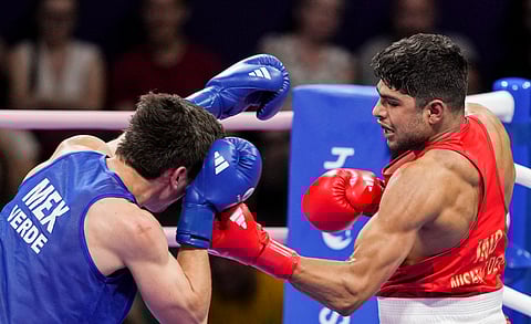 Boxer Nishant Dev in the quarterfinal bout against Marco Verde of Mexico