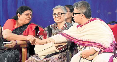 WCC member Deedi Damodharan shakes hands with Kerala Women’s Commission chairperson P Sathidevi at the state-level seminar organised by the commission in Kozhikode. Activist K Ajitha is also seen 