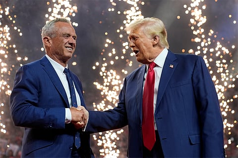 Republican presidential nominee former President Donald Trump shakes hands with Independent presidential candidate Robert F. Kennedy Jr. at a campaign rally at the Desert Diamond Arena, Friday