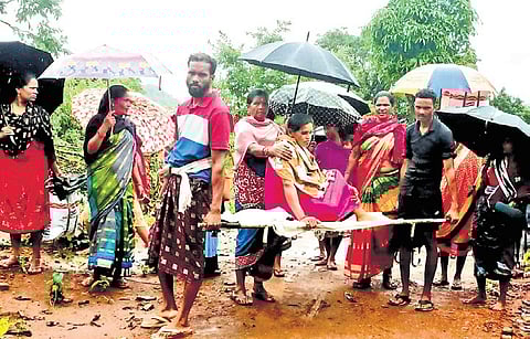 An expectant mother being carried on a stretcher as ambulance could not reach her