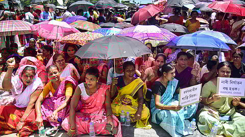 Locals block a road during a protest against an alleged gang-rape of a 14-year-old girl by three men at the Dhing area, in Nagaon district.