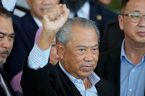Malaysia's former Prime Minister Muhyiddin Yassin poses for media outside courthouse, after charged with corruption and money laundering, in Kuala Lumpur, Malaysia.