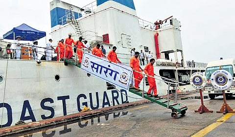  ICG officials rescuing the crew members from the sea