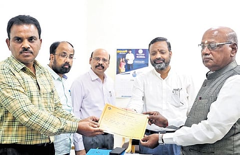 TPCC senior vice-president G Niranjan receives the election certificate from the returning officer on behalf of Abhishek Manu Singhvi  
