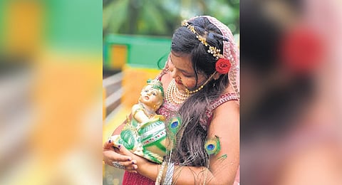 A girl carries Lord Krishna at Jaraka in Jaipur district