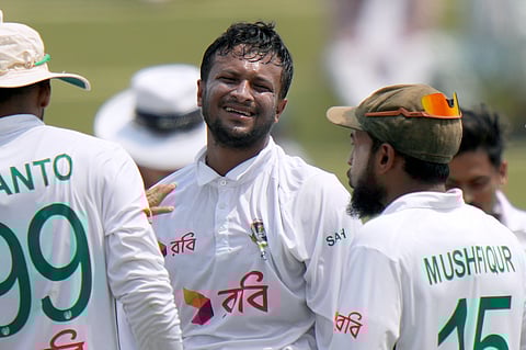 Bangladesh's Shakib Al Hasan, center celebrates with teammates after taking the wicket of Pakistan's Abdullah Shafique in Rawalpindi, Pakistan, Sunday, Aug. 25, 2024. 