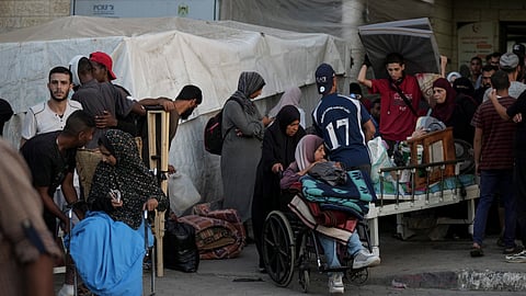 Patients and families move outside the Al-Aqsa Martyrs Hospital in Deir al Balah, Gaza Strip on Sunday