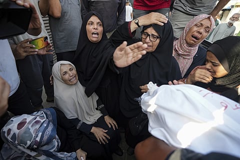 Palestinians mourn relatives killed in Israeli bombardment of the Gaza Strip, at a hospital in Deir al-Balah, Tuesday, August 27, 2024.