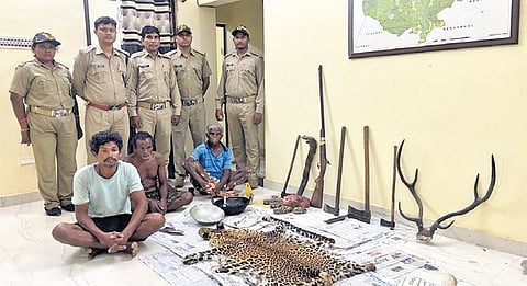 The accused with the seized wildlife items and arms 