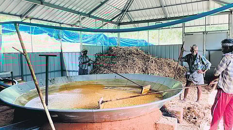 Tribal farmers engaged in jaggery production at the plant at Kanthalloor