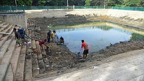 With just 10 days to go for Gowri-Ganesha festival, civic workers start removing silt from the kalyani at Ulsoor Lake. 