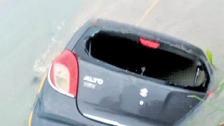 Three people travelling in a car got washed away in the overflowing lake at Pedakakani in Guntur district