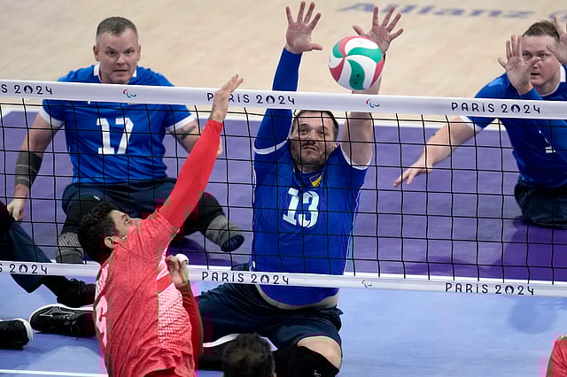 Dmytro Melnyk tries blocking the ball during the men's preliminary game against Iran.