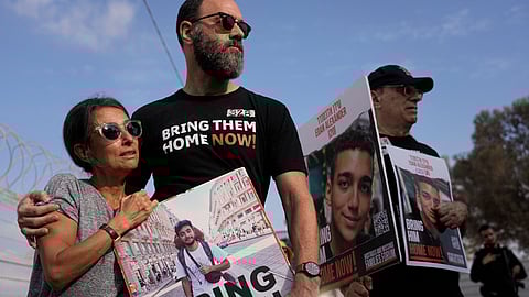 Rachel Goldberg, left, and Jon Polin center, parents of Israeli-American hostage Hersh Goldberg-Polin, along with other relatives of hostages held in the Gaza Strip by the Hamas militant group take part in a protest calling for their release in the Kibbutz Nirim, southern Israel.