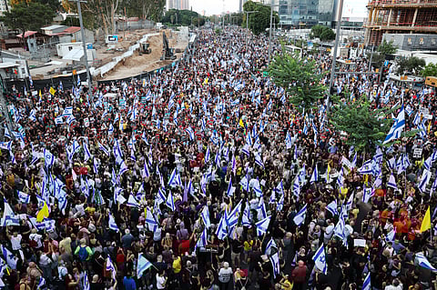 Thousands of protesters lift flags and placards during an anti-government rally calling for the release of Israelis held hostage by Palestinian militants in Gaza since October, in Tel Aviv on September 1, 2024.