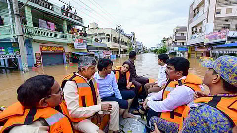 Andhra Pradesh Chief Minister N Chandrababu Naidu with others during a visit to a flood-affected area, in Vijayawada.