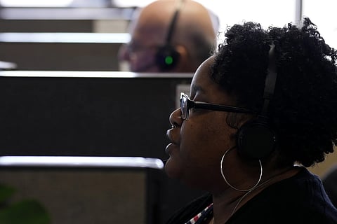 Customer Experience Representative Cassia Jones-Woodard takes calls at an Alorica center, Monday, Aug 19, 2024, in San Antonio. 