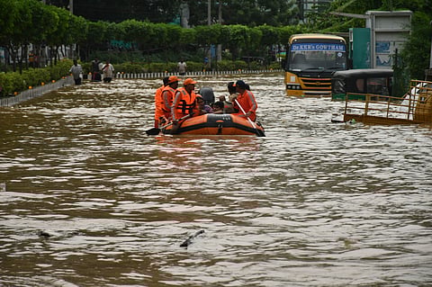 NDRF personnel rescue people from flood affected area at the milk factory in Vijayawada on Monday. 