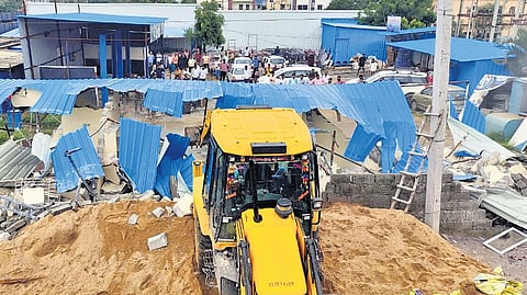 Revenue officials demolishing illegal structures built on government land in Ailapur  village of Ameenpur mandal, Sangareddy district on Tuesday