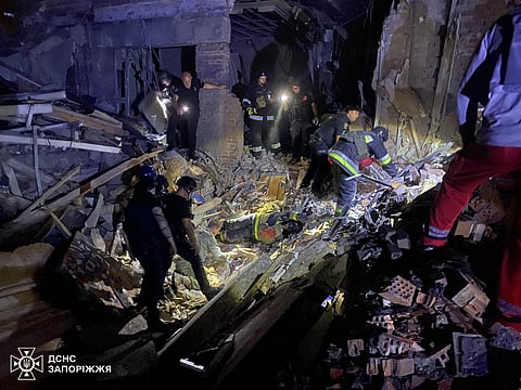 This handout photograph released on September 3, 2024 by Ukrainian State Emergency Service and taken on September 2, 2024 shows rescuers inspecting the rubble of a destroyed hotel after a Russian night strike in Zaporizhzhia.