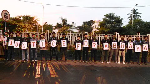 People form a human chain at Eastern Metropolitan Bypass to protest against the alleged sexual assault and murder of a trainee doctor, in Kolkata.
