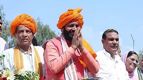 Haryana Chief Minister Nayab Singh Saini greets the gathering during a road show ahead of the upcoming assembly election, on Aug 28, 2024.