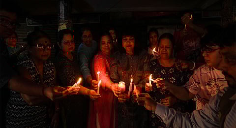 Women hold posters during an early morning protest against the alleged sexual assault and murder of a trainee doctor at Kolkata's RG Kar Medical College and Hospital, in Siliguri, Monday, Sept 9, 2024.