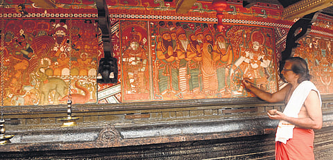 Artist Gopi Chevayur engaged in the restoration work of the murals at Kumaranallur Devi temple