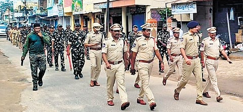 Armed police and special party personnel, led by SP Ghaus Alam, hold a flag march