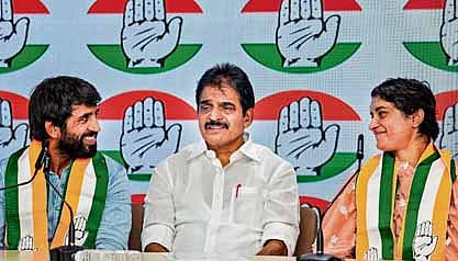 AICC general secretary KC Venugopal with wrestlers Vinesh Phogat and Bajrang Punia at the party headquarters in New Delhi on Friday | PTI