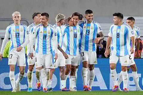 Teammates surround Argentina's Paulo Dybala (10) after he scored his side's third goal against Chile during a qualifying soccer match for the FIFA World Cup 2026 in Buenos Aires.