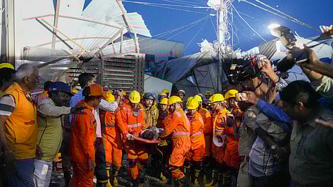 An injured being rescued after a three-storey building collapsed, crushing a truck under its debris, at Transport Nagar area in Lucknow, Saturday, Sept. 7, 2024.