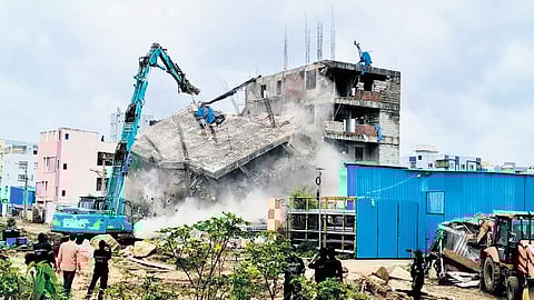 HYDRAA authorities raze unauthorised under-construction structures within the FTL and buffer zone of Sunnam Cheruvu in Madhapur, Hyderabad, on Sunday.